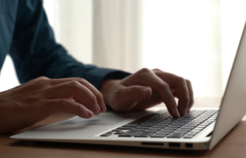 man works on a laptop