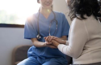 happy patient is holding caregiver for a hand while spending time together